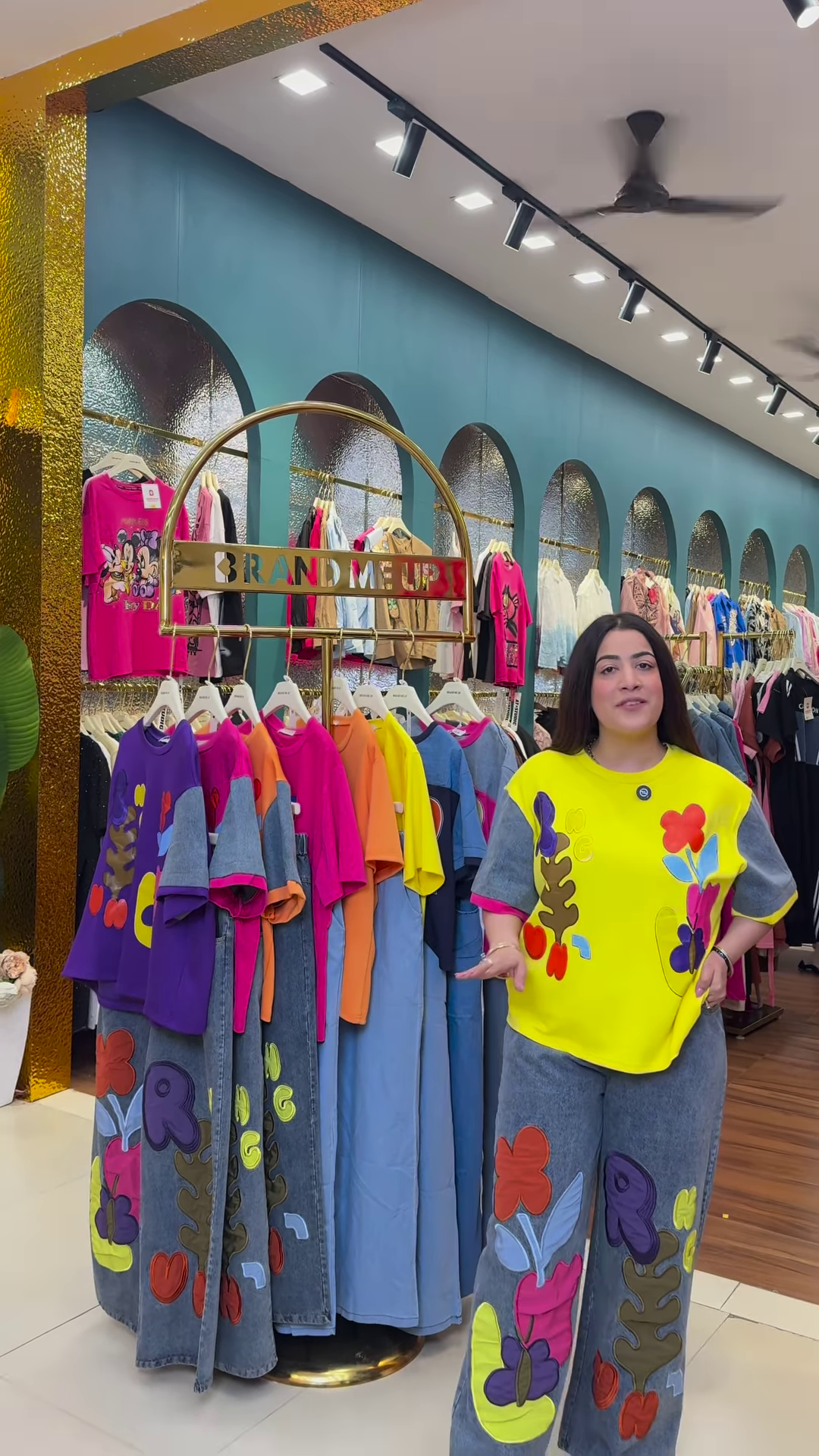 Multicolor Printed Ethnicwear Rack Display – Bold Floral & Abstract Garments in Boutique Interior with Teal-Gold Accents